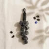 Black Tourmaline crystal hanger styled with raw Black Tourmaline stones and an evil eye charm