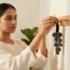 Black Tourmaline crystal hanger being placed on a wall hook