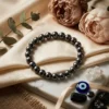 Hematite crystal bracelet 8mm styled with black tourmaline, evil eye charm and clear quartz crystals