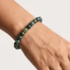 Close-up of polished 8mm Moss Agate crystal bracelet
