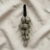 Pyrite crystal hanger displayed on textured fabric with natural pyrite stones