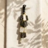 Selenite and Black Tourmaline crystal hanger displayed on textured fabric