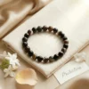 Suleimani Black Hakik crystal bracelet styled with soft neutral decor, flowers and healing crystal elements for an elegant aesthetic look