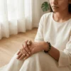 Woman wearing Suleimani Black Hakik crystal bracelet in a minimal indoor setting symbolizing grounding, protection and balance