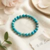 African turquoise crystal bracelet styled with soft flowers and minimal aesthetic