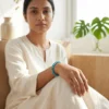 Woman wearing African turquoise crystal bracelet in a calm indoor setting