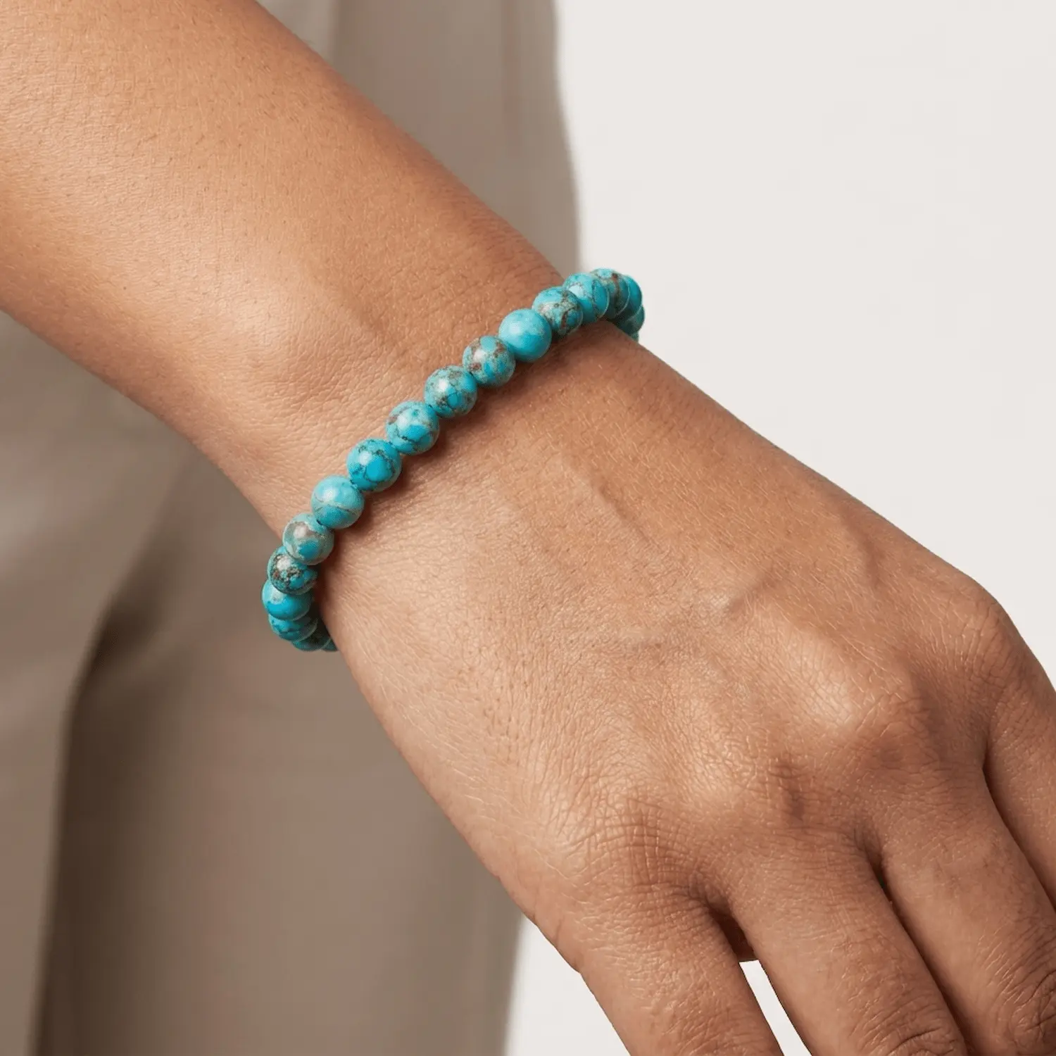 Close-up of African turquoise crystal bracelet on wrist showing bead texture