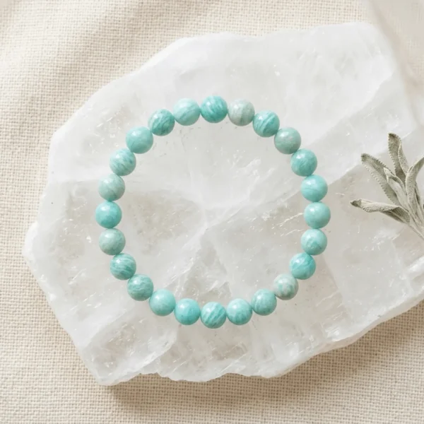 Amazonite crystal bracelet 8mm with round blue-green beads on white selenite background