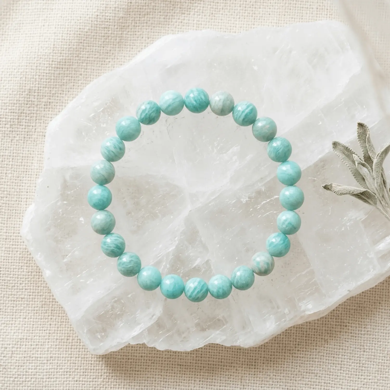 Amazonite crystal bracelet 8mm with round blue-green beads on white selenite background
