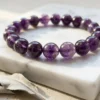 Detailed view of amethyst crystal bracelet beads showing natural inclusions