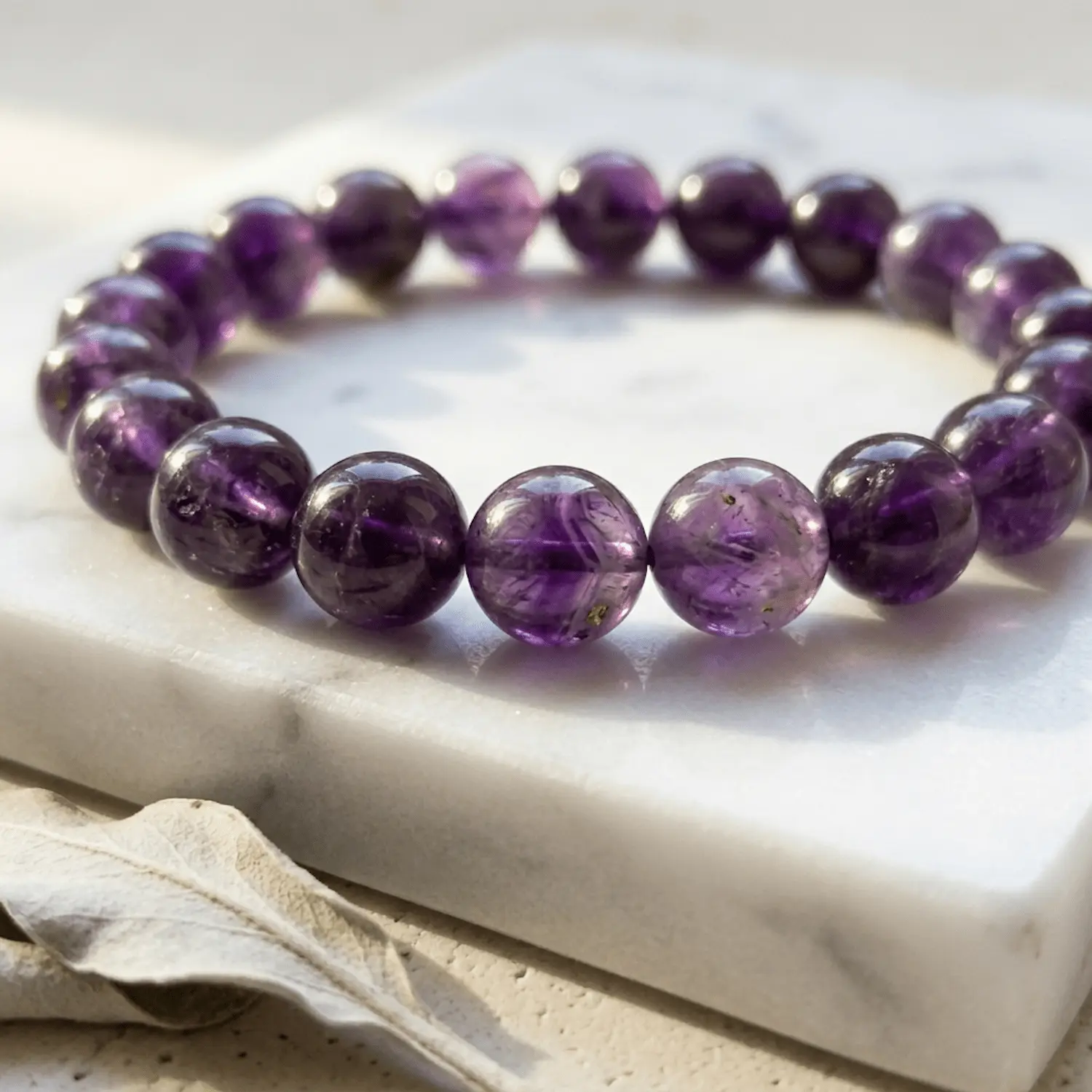 Detailed view of amethyst crystal bracelet beads showing natural inclusions