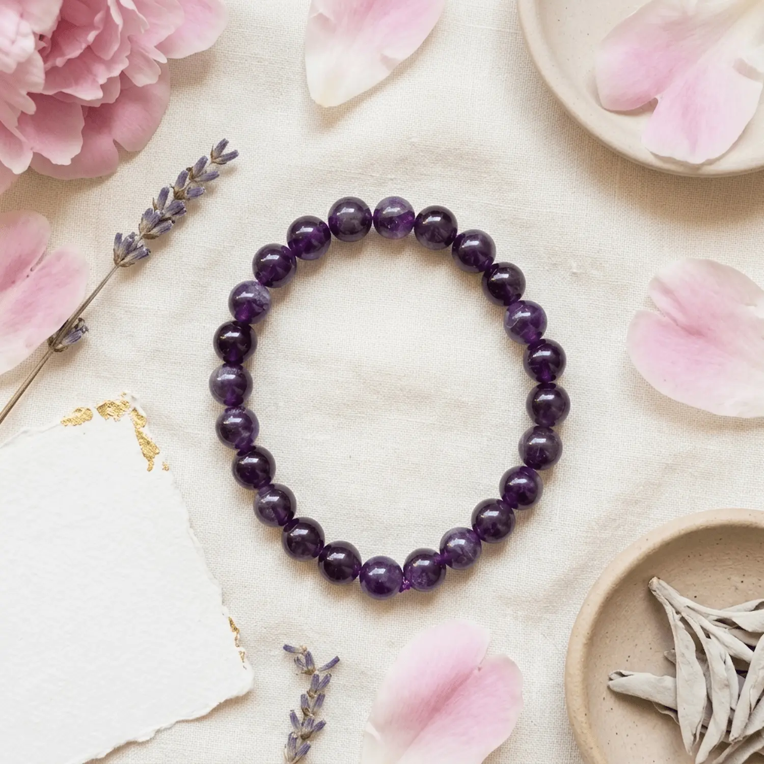 Amethyst crystal bracelet styled with flowers and minimal aesthetic elements