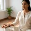 Woman wearing amethyst crystal bracelet while meditating indoors