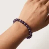 Close-up of amethyst 8mm crystal bracelet on wrist showing bead color and shine
