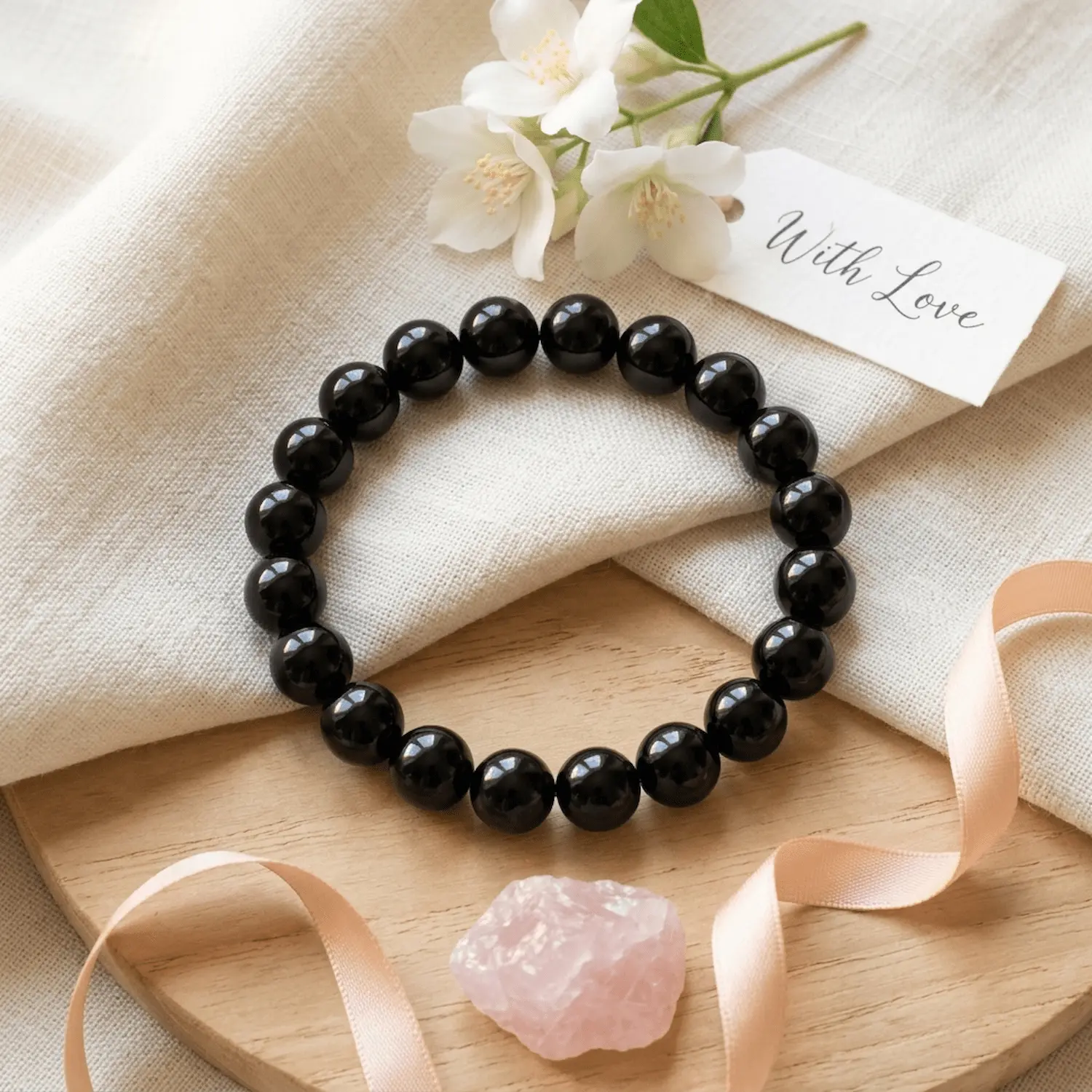 10mm Black obsidian crystal bracelet styled with flowers and minimal aesthetic elements