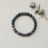 8mm Bloodstone crystal bracelet on neutral fabric background showing natural bead variation