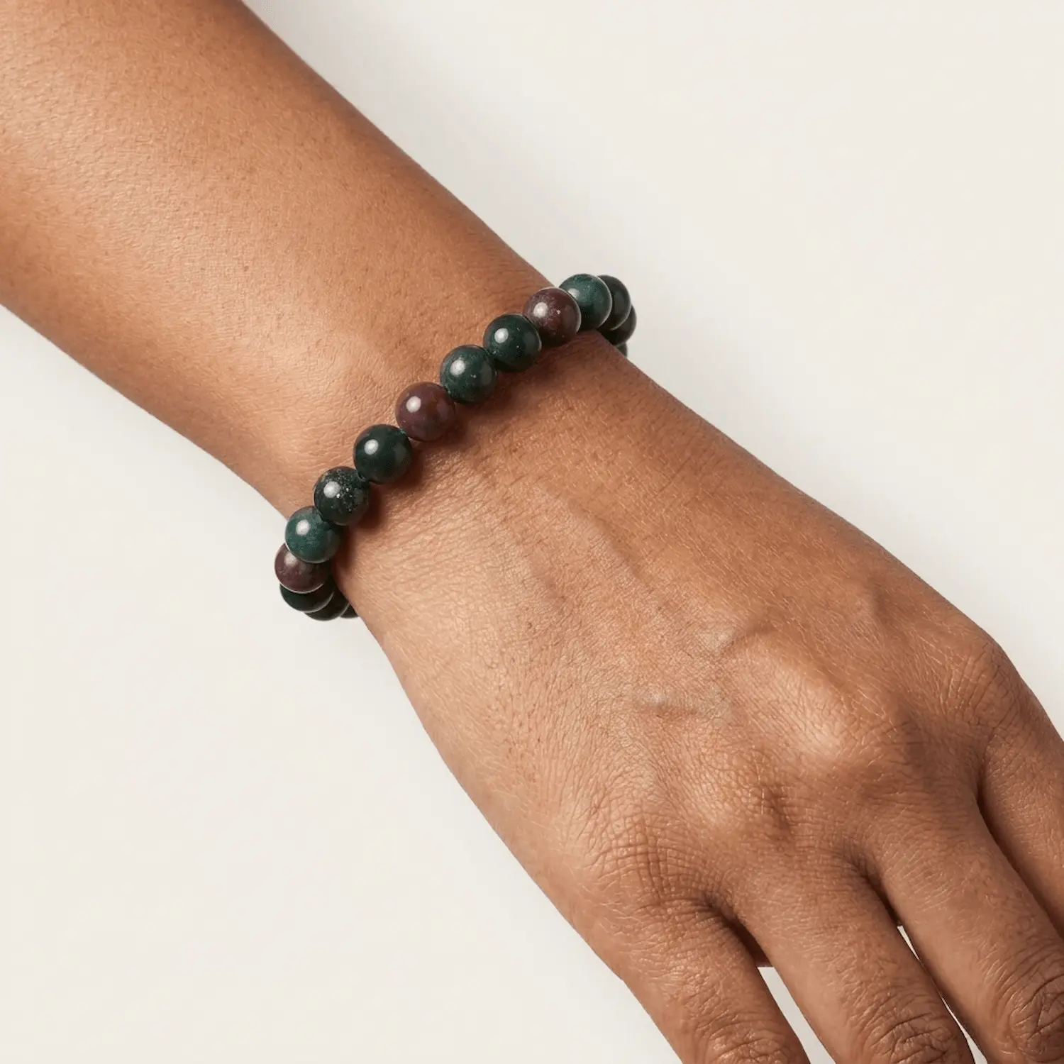 Close-up of a 8mm bloodstone crystal bracelet on wrist highlighting bead size and texture