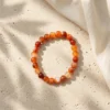 8mm Carnelian crystal bracelet on neutral background highlighting natural banding patterns
