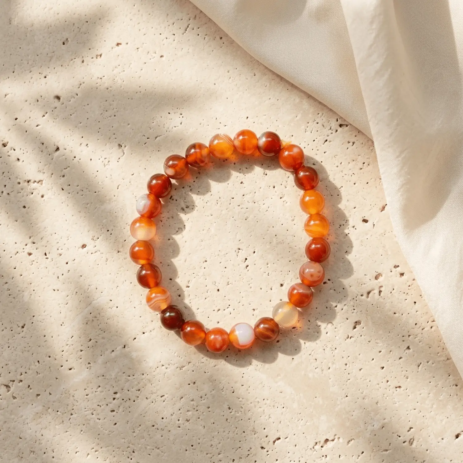 8mm Carnelian crystal bracelet on neutral background highlighting natural banding patterns