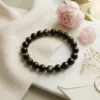8mm Golden obsidian crystal bracelet styled with soft decor showing natural bead variation