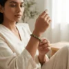 Woman wearing a 8mm green jade crystal bracelet in a calm setting