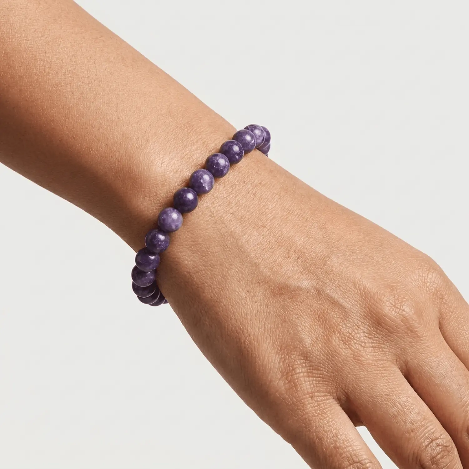 Lepidolite crystal bracelet 8mm worn on wrist showing bead size