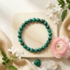 Malachite crystal bracelet with natural green banding styled with flowers and decor