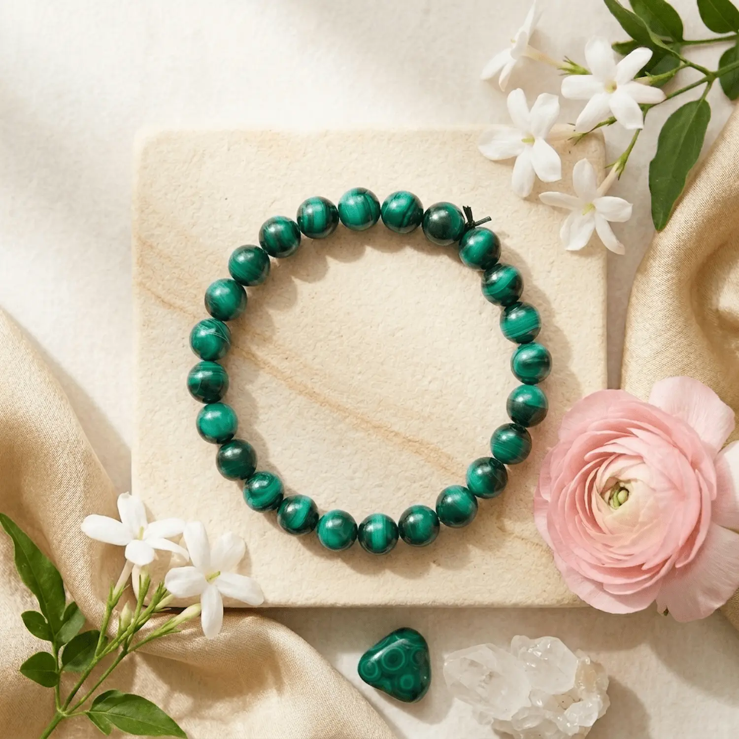 Malachite crystal bracelet with natural green banding styled with flowers and decor