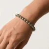Close up of pyrite crystal bracelet on wrist showing bead size and metallic finish