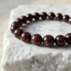 Macro close up of 8mm red garnet crystal beads showing deep red translucency and texture