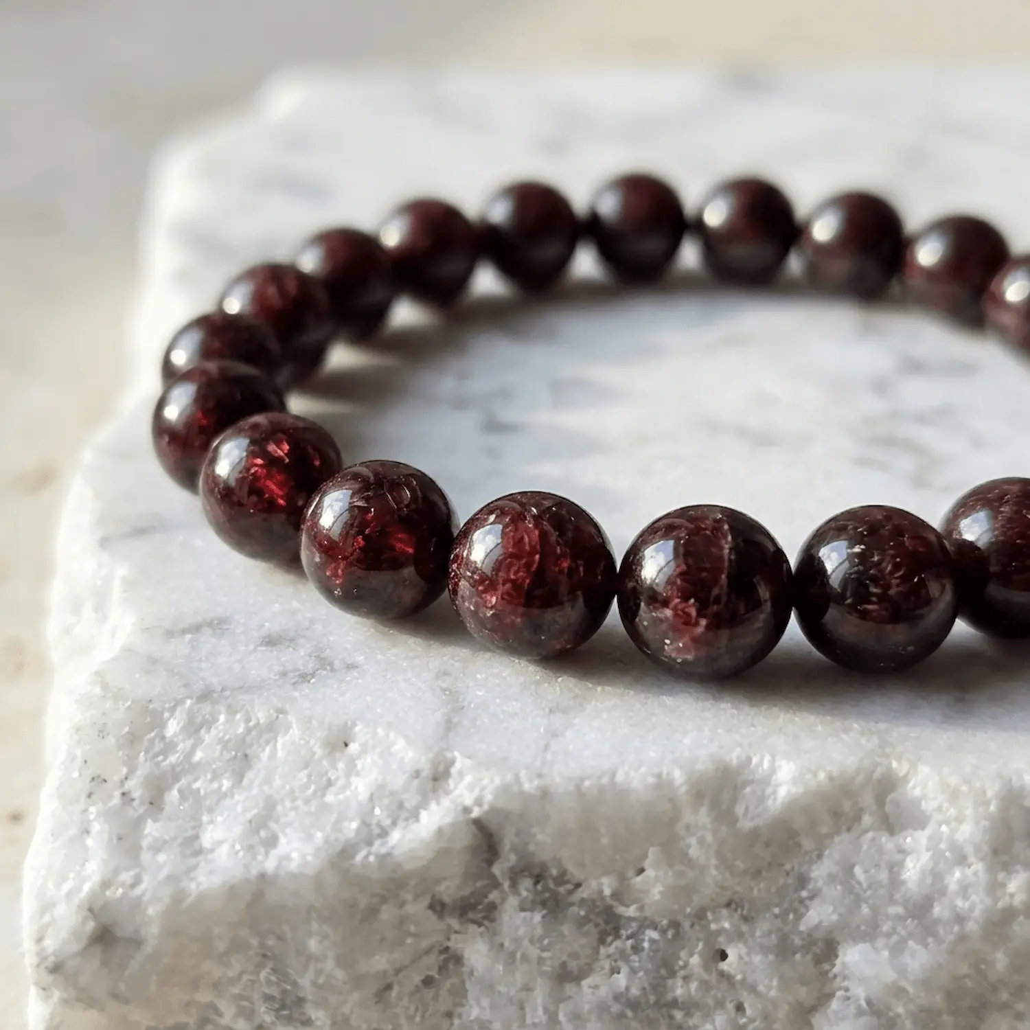 Macro close up of 8mm red garnet crystal beads showing deep red translucency and texture