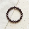 8mm Red garnet crystal bracelet with round polished deep red beads on neutral background