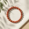 Red Jasper crystal bracelet 8mm with polished round beads showcasing rich earthy red tones and natural stone patterns