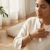 Woman wearing Serpentine crystal bracelet during meditation, promoting emotional healing, balance and inner calm