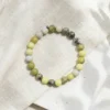 Serpentine crystal bracelet 8mm with polished round beads in mixed green and yellow tones showing natural patterns