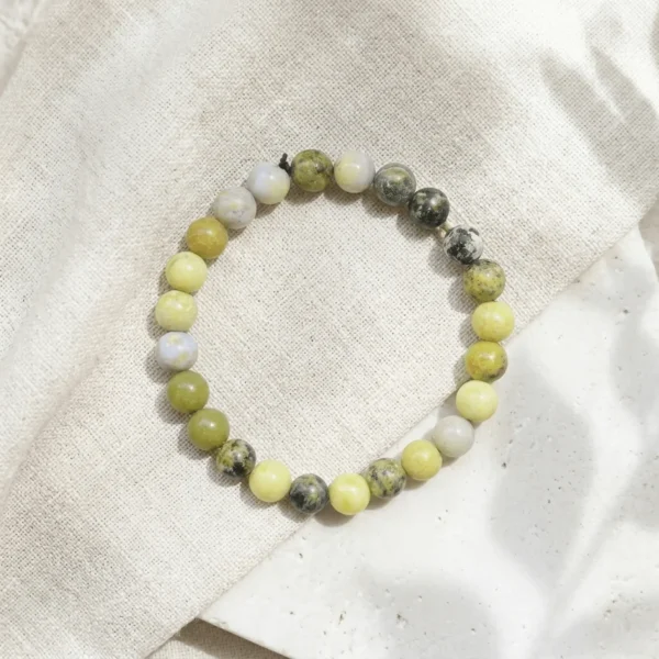 Serpentine crystal bracelet 8mm with polished round beads in mixed green and yellow tones showing natural patterns