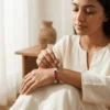 Woman wearing seven chakra crystal bracelet in a calm indoor setting
