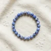 Sodalite crystal bracelet 8mm with round polished blue beads featuring natural white patterns on neutral background