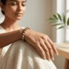 Woman wearing Unakite crystal bracelet in a calm indoor setting highlighting emotional balance, healing and grounding energy