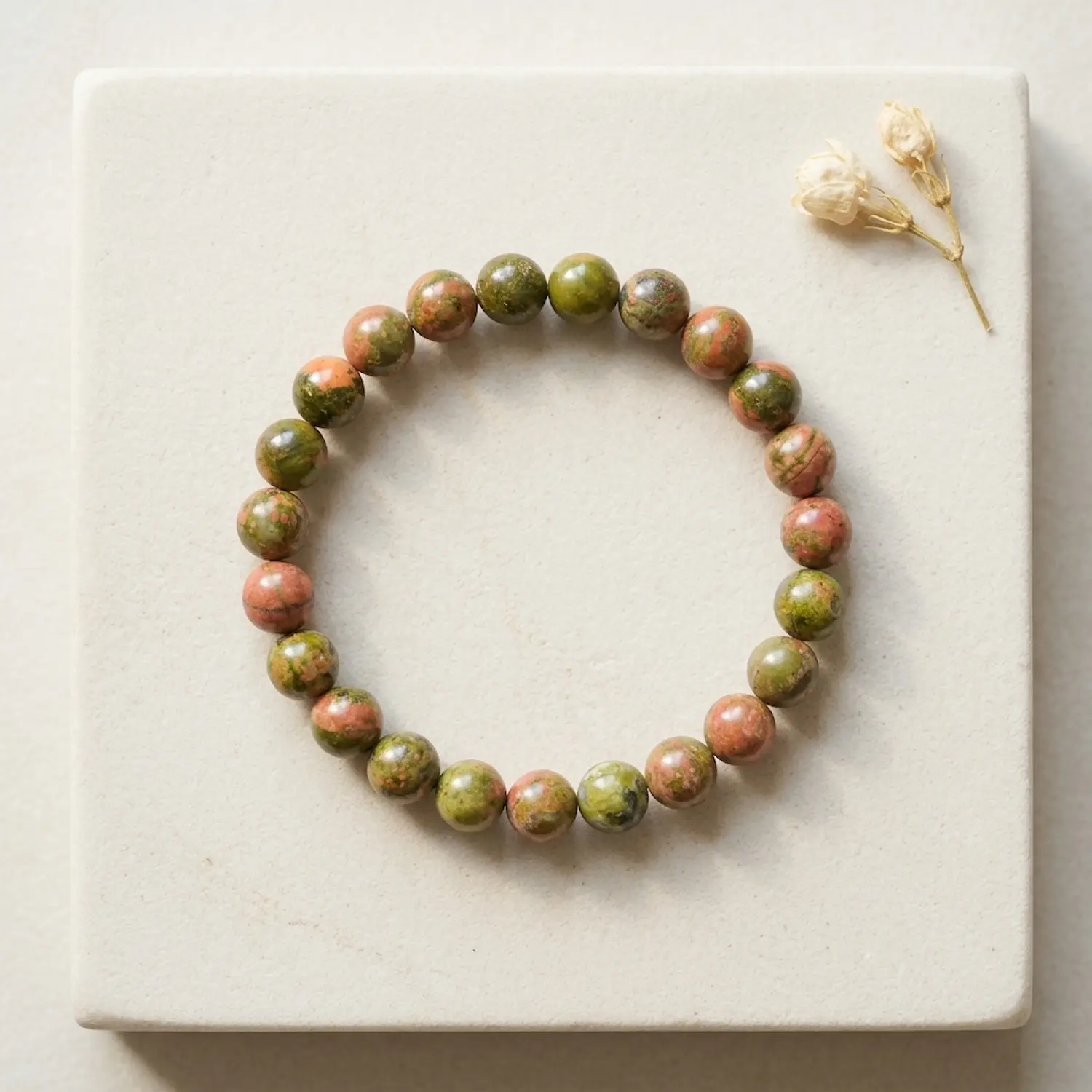 Unakite crystal bracelet 8mm with polished round beads showing natural green and pink mineral patterns on neutral background