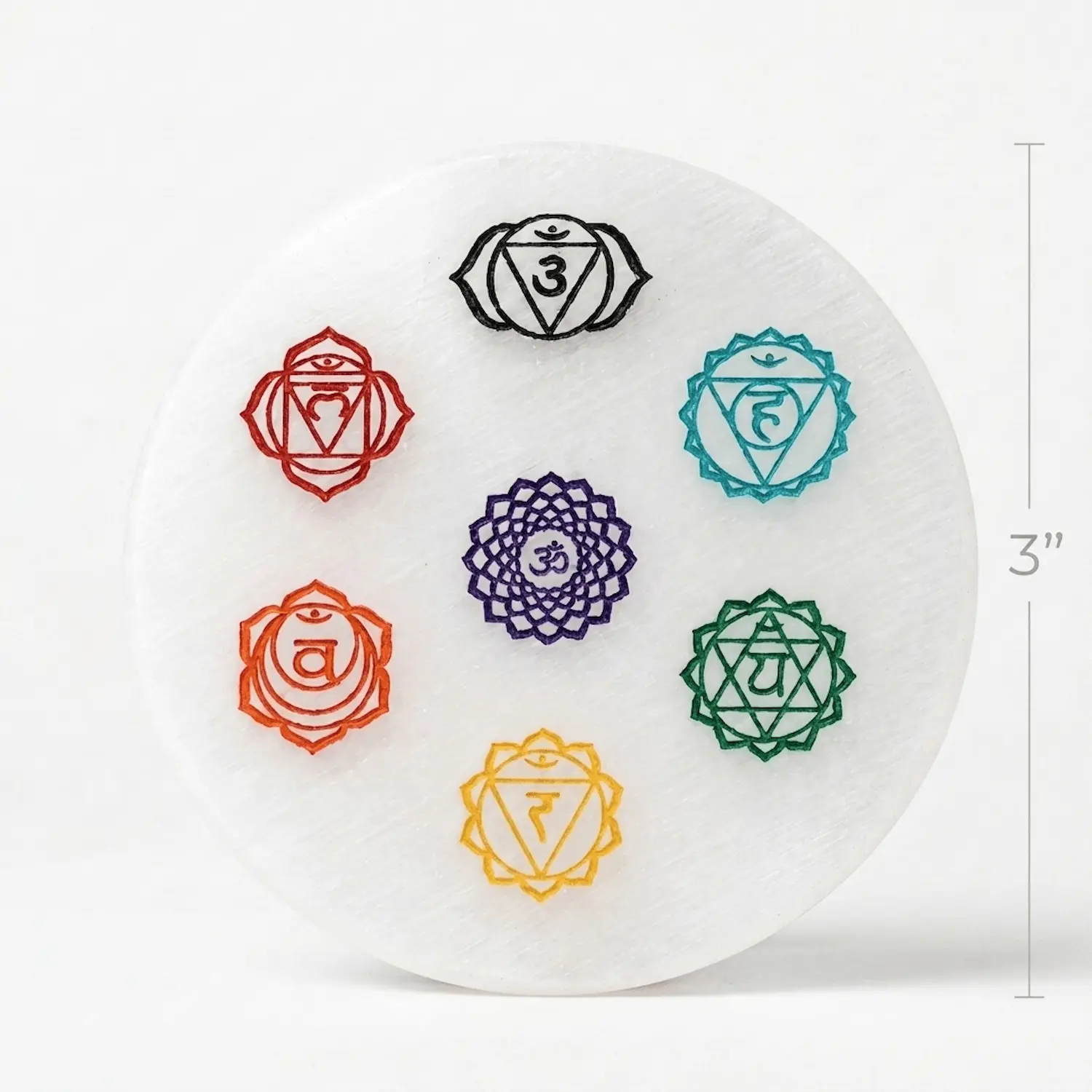Round selenite chakra plate photographed on a white background