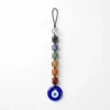 7 Chakra tumble stone hanger with Evil Eye photographed against a clean white background